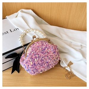Detailed view of pink sequin shell bag with pearl handle and golden chain strap