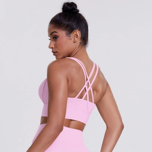 Close-up of pink sports bra featuring multi-cross strappy back design and elastic hem