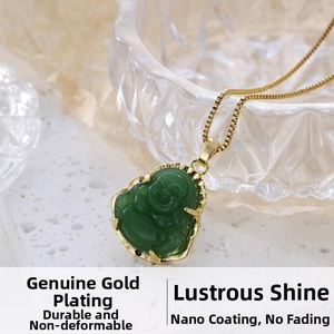 Close-up of green Buddha pendant with gold frame on a textured surface
