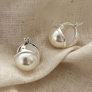 Elegant 925 silver irregular pearl hoop earrings on minimalist rustic linen background