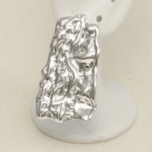 Macro shot of silver liquid-metal earrings with irregular molten texture and molten finish