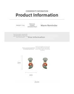 Detailed view of conch shell earrings with rhinestones, pearls, and copper base