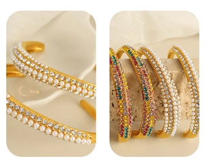 Macro detail of gold open bangle featuring three rows of crystals and pearl accents