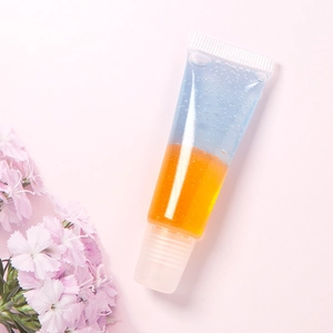 Detail of clear squeeze tube showing dual-layered blue and orange glossy lip gel