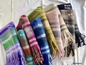 Detailed view of plaid scarves in various color options with soft cashmere-like fringe