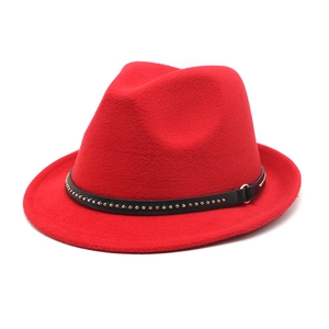 Detail of red wool fedora hat featuring black leather band and metal rivet buckles
