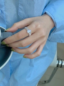 Detailed shot of irregular 925 silver ring with rectangular zircon on hand