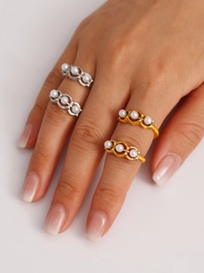 Macro shot of two-tone adjustable rings featuring three pearls and zircon accents
