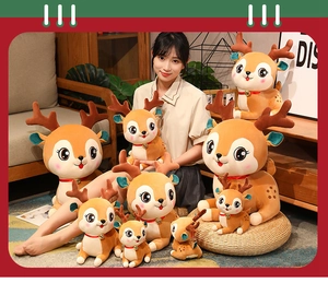 Various sizes of Christmas reindeer plush toys with bells and red ribbons in a cozy setting