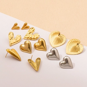 Detail of 304 stainless steel heart earrings with gold plating and diverse textures