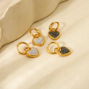 Detail view of 18K gold plated stainless steel hoop earrings with crystal heart pendants