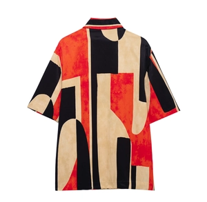 Detail view of the back of short sleeve shirt with bold red black geometric pattern