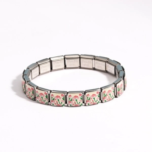 Detail of Italian charm bracelet showing pink floral enamel design and stainless steel link