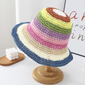 Rainbow striped woven straw sun hat for women displayed on a wooden stand