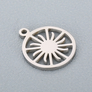 Macro shot of silver hollow sun gear pendant in stainless steel for DIY jewelry making