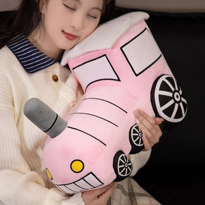 Pink cartoon train plush pillow toy for kids, soft stuffed doll in a cozy home setting