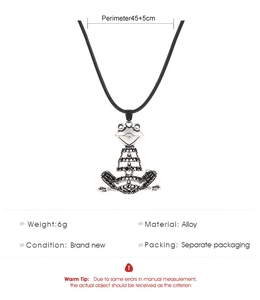 Macro detail of silver frog pendant featuring black rhinestone inlay and alloy texture