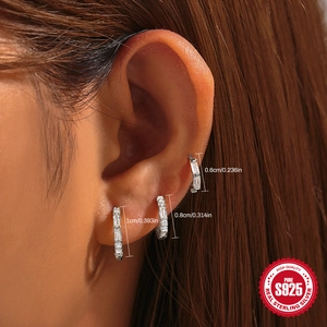 Classic S925 sterling silver hoop earrings set with zircon stones worn on ear