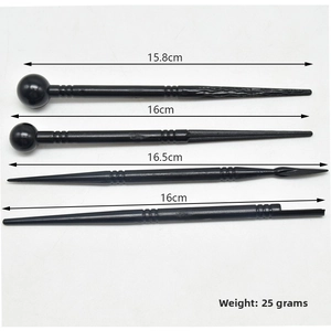 Detail of 4-piece black plastic fondant modeling tools with various shaping heads and sizes