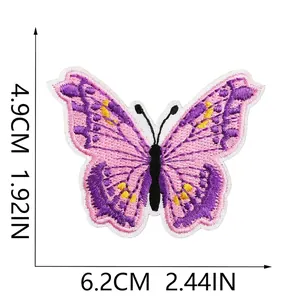 Detail showing embroidered blue butterfly patch dimensions 4.9cm by 6.2cm for clothing