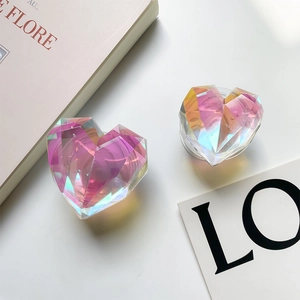 Detailed view of colorful laser heart phone grips with diamond-cut finish on a desk