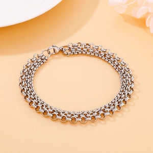 Three-layer silver stainless steel chain bracelet with pearl details on orange background