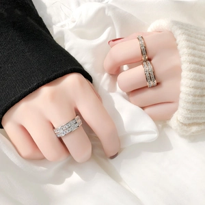 Close-up of sparkling titanium steel eternity rings with inlaid cubic zirconia on model hands