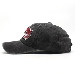 Close-up of vintage washed cotton baseball cap with detailed red and white embroidery