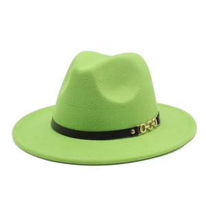 Detail of neon green wide brim fedora with black ribbon and gold chain buckle