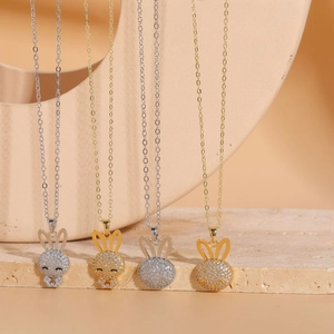 Detailed view of silver and gold rabbit pendants with sparkling cubic zirconia inlay