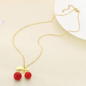 Minimalist stainless steel necklace featuring red cherry pendant with golden chain