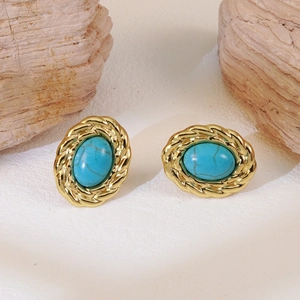 Detail of vintage oval stud earrings with gold metal edges and turquoise inlay