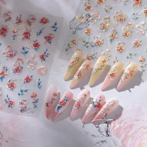 Detailed view of floral and snake nail stickers with 3D embossed texture and finished tips