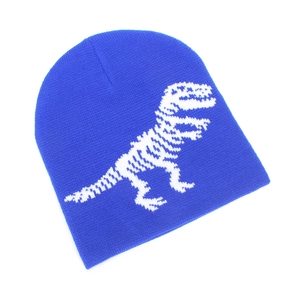 Detailed knit texture of royal blue kids beanie with white dinosaur skeleton pattern