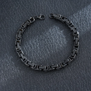Detailed macro view of a men's black stainless steel Byzantine link chain bracelet
