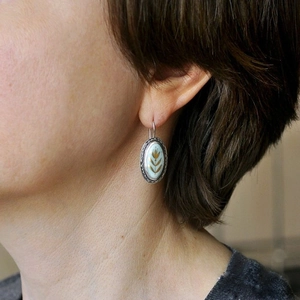 Elegant gold flower blue enamel oval drop earrings on model for vintage look