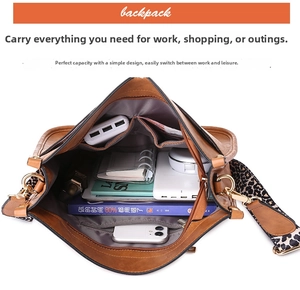 Spacious interior of brown vintage tote bag with leopard strap holding gadgets