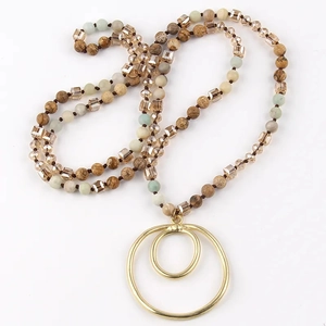 Detailed view of bohemian double-ring pendant with natural stone and crystal beads