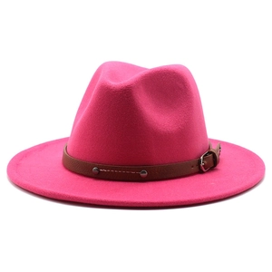 Detail of rose red fedora hat featuring brown leather belt strap and metallic rivets
