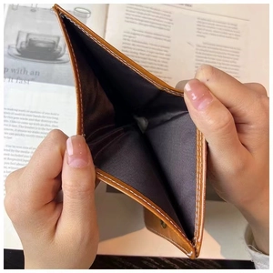Detail showing the brown leather wallet interior structure with smooth dark lining