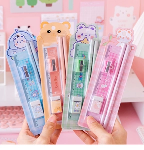 Close-up of four colorful cartoon stationery sets with rulers, pencils, and sharpeners