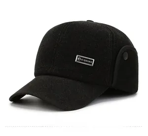 Dettaglio del cappello invernale con paraorecchie pieghevoli e placca metallica con logo