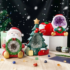 Handcrafted Christmas tree and Santa figurines with natural crystal geode and warm glow