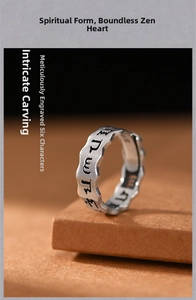 Macro detail of vintage hollow engraved mantra ring with Buddhist scripture on silver band