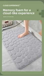 Detail of grey memory foam bath mat featuring a 3D pebble pattern and soft texture