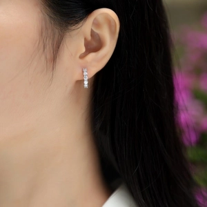 Minimalist S925 sterling silver hoop earrings with five clear moissanite stones on ear