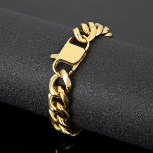 Macro shot of 15mm polished gold Cuban chain bracelet featuring a secure box clasp