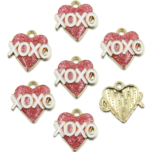 Detail of 7 heart-shaped red glitter XOXO charms with gold metallic plating for DIY jewelry