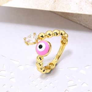Macro shot of pink evil eye copper ring with bead band and teardrop zircon detail