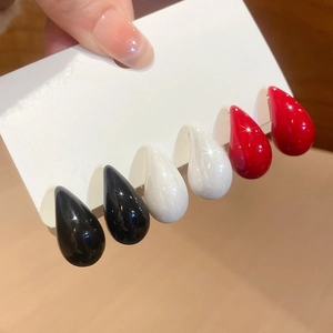 Detailed set of teardrop earrings in black, white, and red with a high-gloss finish